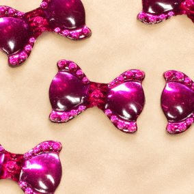 Magenta nagyméretű masnidíszek világos champagne háttéren